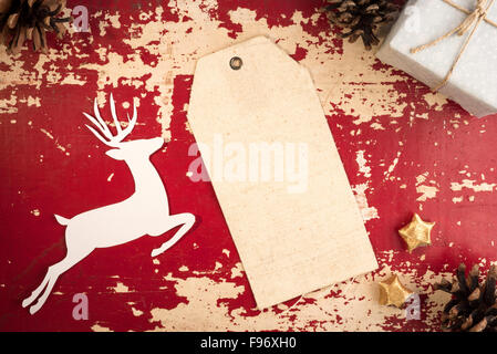 Merry Christmas vintage top view fabric hang tag label template with paper cut deer silhouette and holiday decoration elements Stock Photo