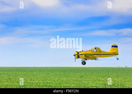 Crop duster airplane spraying farm field, Saskatchewan, Canada. Stock Photo