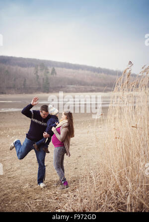 Happy young family spending time together in nature. Stock Photo