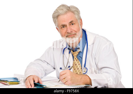 Middle-aged doctor doing paperwork Stock Photo
