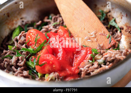 Preparing ragu alla Bolognese in a pan - detail Stock Photo