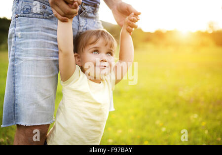 Hipster father playing with his little daughter in the green park. Stock Photo
