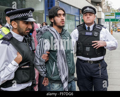 London, UK. 14th December, 2015. File Images from 18th April 2014: British-based Islamist Nadir Syed found guilty of murder plot. Seen here being arrested after a clash with police and far right protest groups outside Regents Park Mosque in London Credit:  Guy Corbishley/Alamy Live News Stock Photo