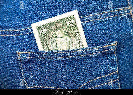 One dollar bill sticking out of the blue jeans pocket Stock Photo