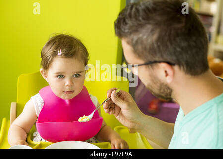 Young father and his little daughter having breakfast together Stock Photo