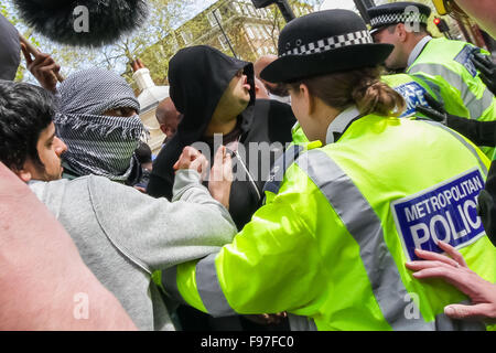 London, UK. 14th December, 2015. File Images from 18th April 2014: British-based Islamist Nadir Syed found guilty of murder plot. Seen here (left, in headscarf) during a clash with police and far right protest groups outside Regents Park Mosque in London Credit:  Guy Corbishley/Alamy Live News Stock Photo