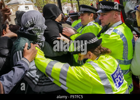 London, UK. 14th December, 2015. File Images from 18th April 2014: British-based Islamist Nadir Syed found guilty of murder plot. Seen here (left, in headscarf) during a clash with police and far right protest groups outside Regents Park Mosque in London Credit:  Guy Corbishley/Alamy Live News Stock Photo