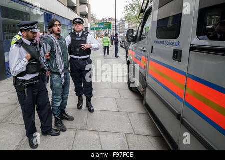 London, UK. 14th December, 2015. File Images from 18th April 2014: British-based Islamist Nadir Syed found guilty of murder plot. Seen here being arrested during a clash with police and far right protest groups outside Regents Park Mosque in London Credit:  Guy Corbishley/Alamy Live News Stock Photo