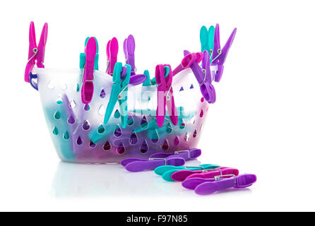 Colorful basket of pegs on white background Stock Photo