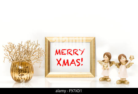 Golden frame and Christmas decorations Angels. Greeting card concept with sample text Merry Xmas! Stock Photo