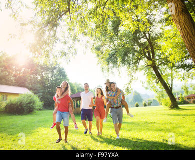 Group of five teenage friends having fun in park Stock Photo