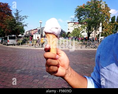 Cropped Image Of Man Holding Ice Cream At Street