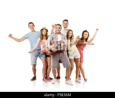 Group of happy young people having fun with guitar, isolated on white background. Best friends Stock Photo
