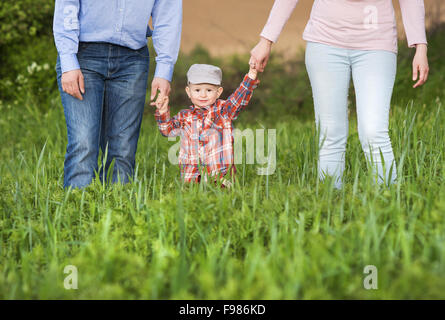 Happy family playing with son on the meadow Stock Photo