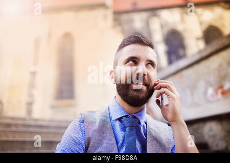 Handsome hipster modern businessman using smart phone in the city Stock Photo