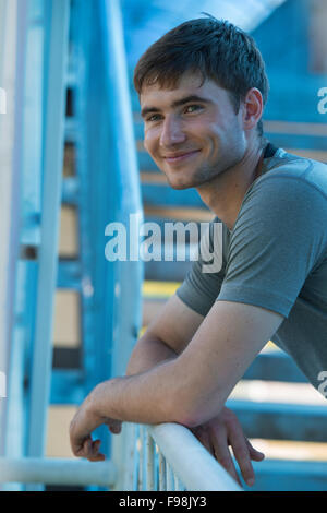 Resting athlete man tired after a long running sport event in the city Stock Photo