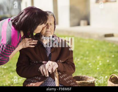 Senior woman with daughter taking care of her Stock Photo