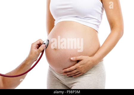 Unrecognizable pregnant woman being given prenatal check by doctor, isolated on white background Stock Photo