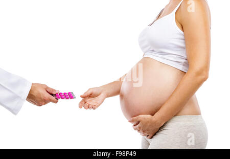 Unrecognizable pregnant woman being given prenatal check by doctor, isolated on white background Stock Photo