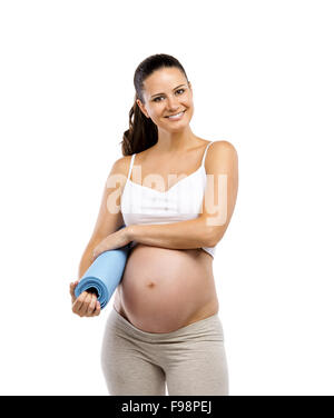 Studio portrait of a beautiful young pregnant woman holding mat ready for exercising, isolated on white background Stock Photo