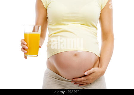 Unrecognizable pregnant woman holding glass of orange juice, isolated on white background Stock Photo