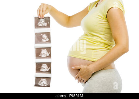 Studio portrait of a unrecognizable pregnant woman holding ultrasound scan picture isolated on white background Stock Photo