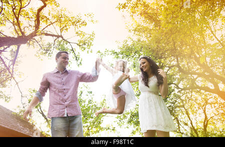 Happy pregnant family having fun in garden near the old farmhouse Stock Photo