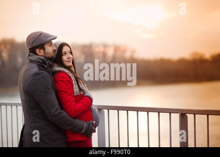 Young pregnant couple portrait in winter town Stock Photo