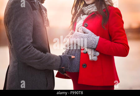 Young pregnant couple portrait in winter town Stock Photo