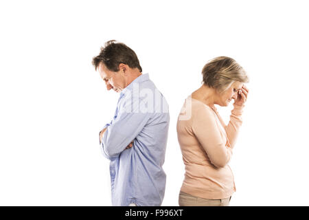 Studio shot of angry senior couple having an argument, isolated on white background. Marriage in crisis. Stock Photo