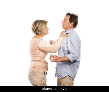 Studio shot of angry senior couple having an argument, isolated on white background. Marriage in crisis. Stock Photo