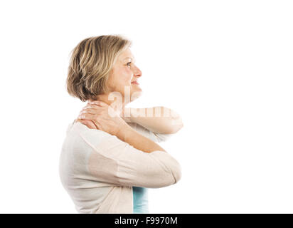 Senior woman suffering from neck pain, isolated on white background Stock Photo