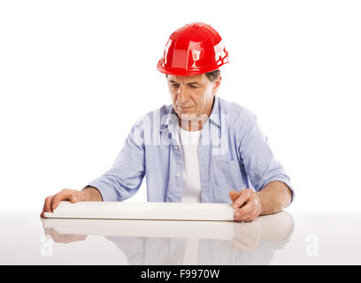 Portrait Of Happy Senior Engineer Holding Plans Isolated Over White Background Stock Photo