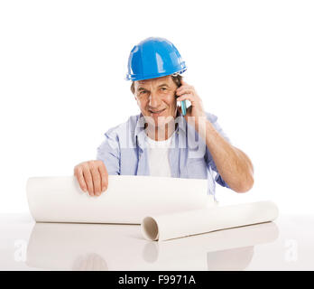 Portrait Of Happy Senior Engineer Making Phone Call And Looking To Plans Isolated Over White Background Stock Photo