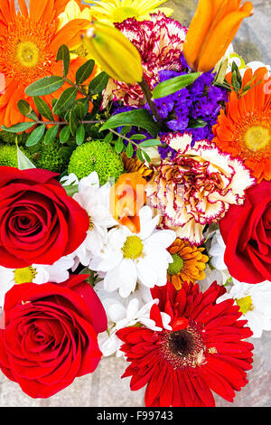 Red roses and gerbera daisies in colorful bouquet Stock Photo