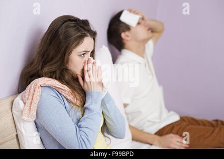 Sick woman and man have cold, flu and high fever.