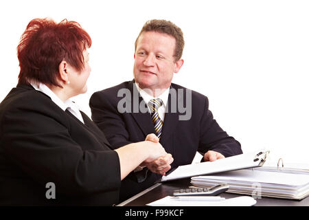 Two senior people sealing a deal with handshake Stock Photo