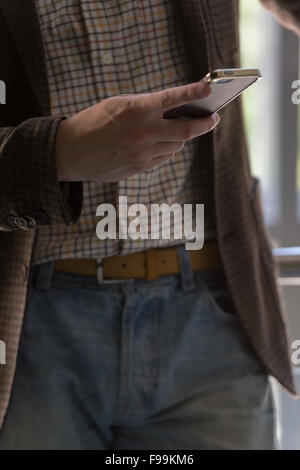 Unrecognizable stylish businessman texting on the phone in office Stock Photo