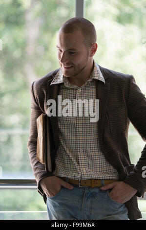 Relaxed businessman standing in office Stock Photo