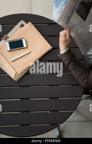 Handsome businessman or manager in office building reading newspaper view from above Stock Photo