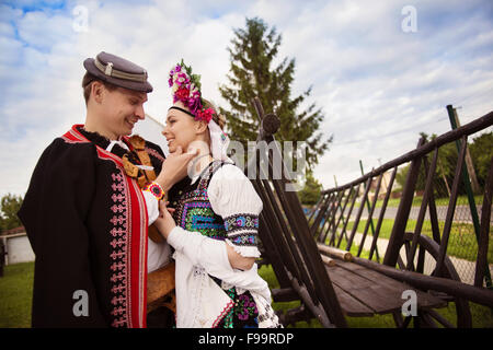 Love couple wearing traditional Eastern Europe folk costumes. Stock Photo