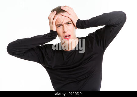 Portrait of a stressed man touching his head isolated on a white background Stock Photo