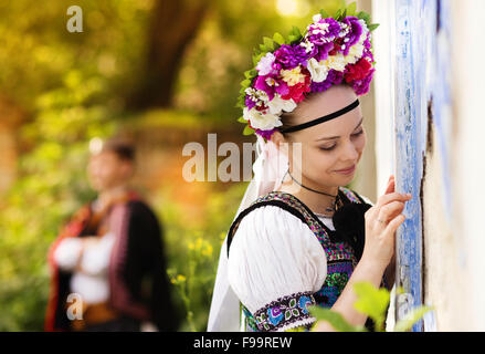 Love couple wearing traditional Eastern Europe folk costumes. Stock Photo