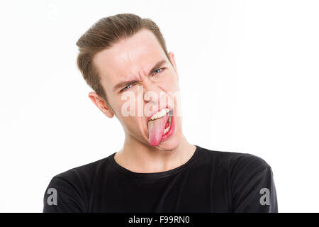 Portrait of a young man showing his tongue isolated on a white background Stock Photo