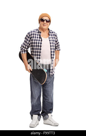 Full length portrait of a cool senior skater holding a skateboard and looking at the camera isolated on white background Stock Photo