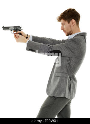 Handsome young man aiming the gun to an invisible target Stock Photo