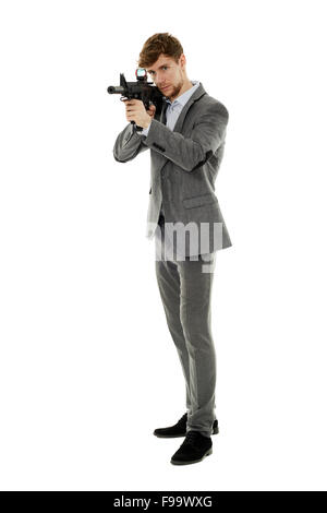 Handsome caucasian guy aiming the machine gun at invisible target isolated on white Stock Photo