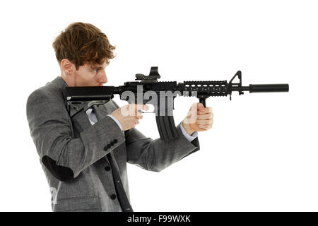 Handsome caucasian guy aiming the machine gun at invisible target isolated on white Stock Photo