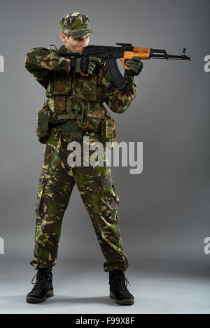 Young Soldier Aiming With Gun Over White Background Stock Photo - Alamy