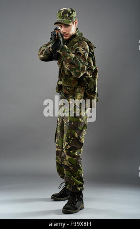Young Soldier Aiming With Gun Over White Background Stock Photo - Alamy